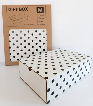 Image shows a black and white polka dot gift box