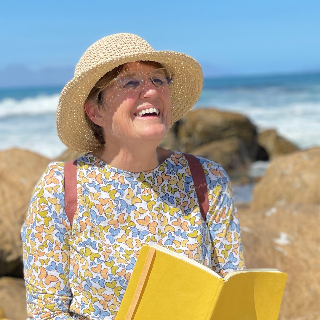 Image shows a woman holding a Flexi softcover journal in hand