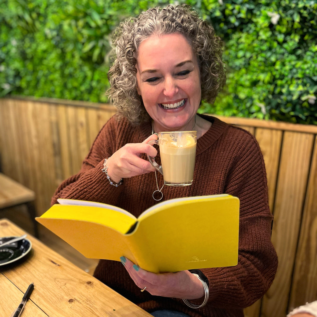 Image shows a lady sitting with a Yellow Flexi Multiplanner