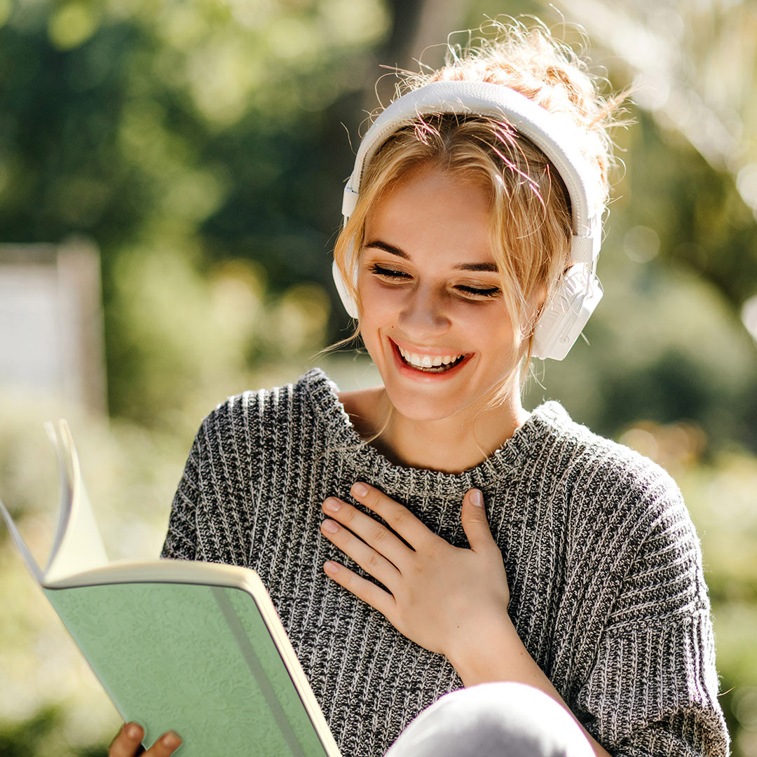 Image shows a woman holding a Premium Flexi journal in hand