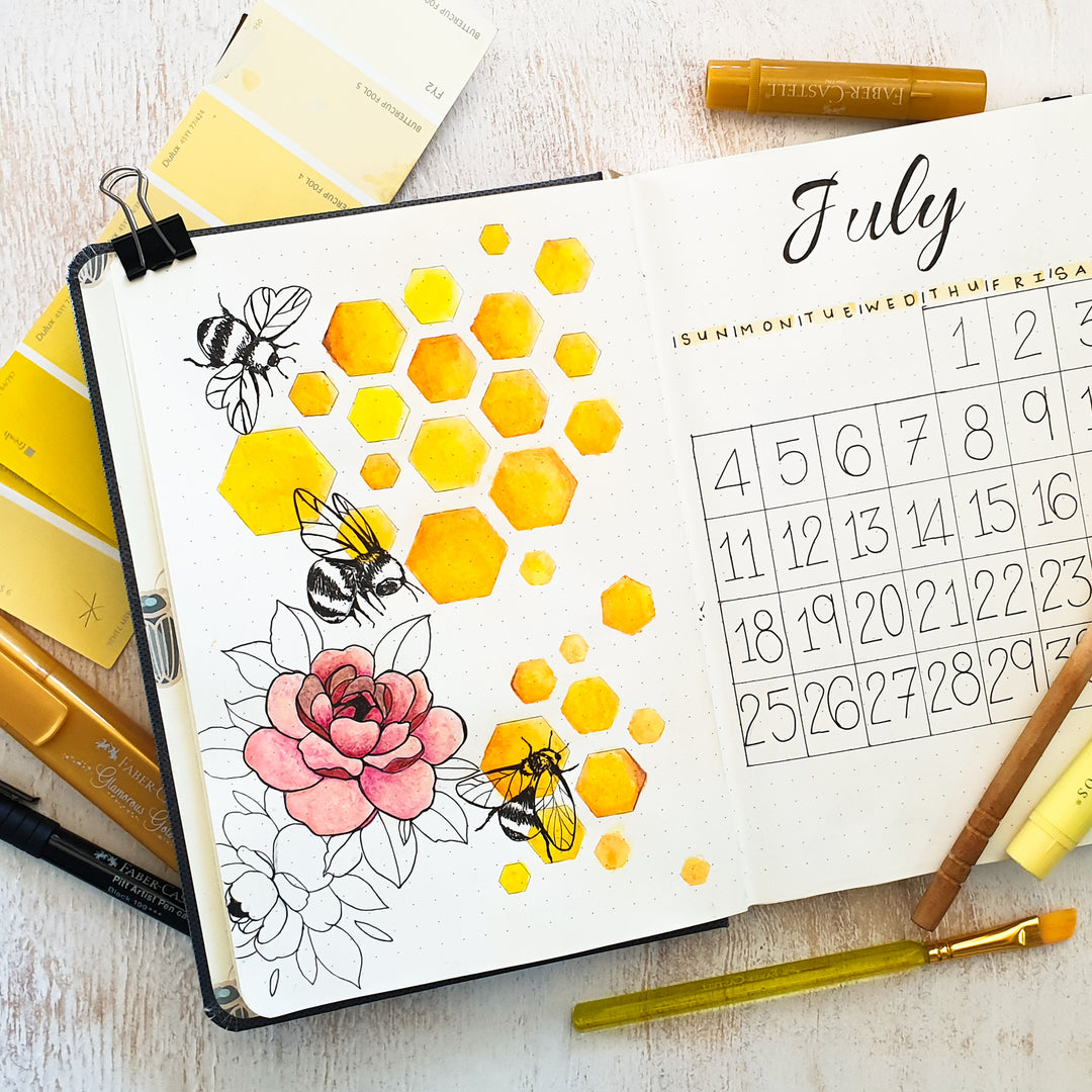 Image shows a bee themed journal spread in a premium hardcover journal