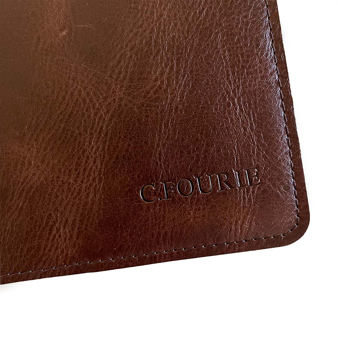 Image shows a Rustik leather slip on journal with a personalized (debossed) design on the cover
