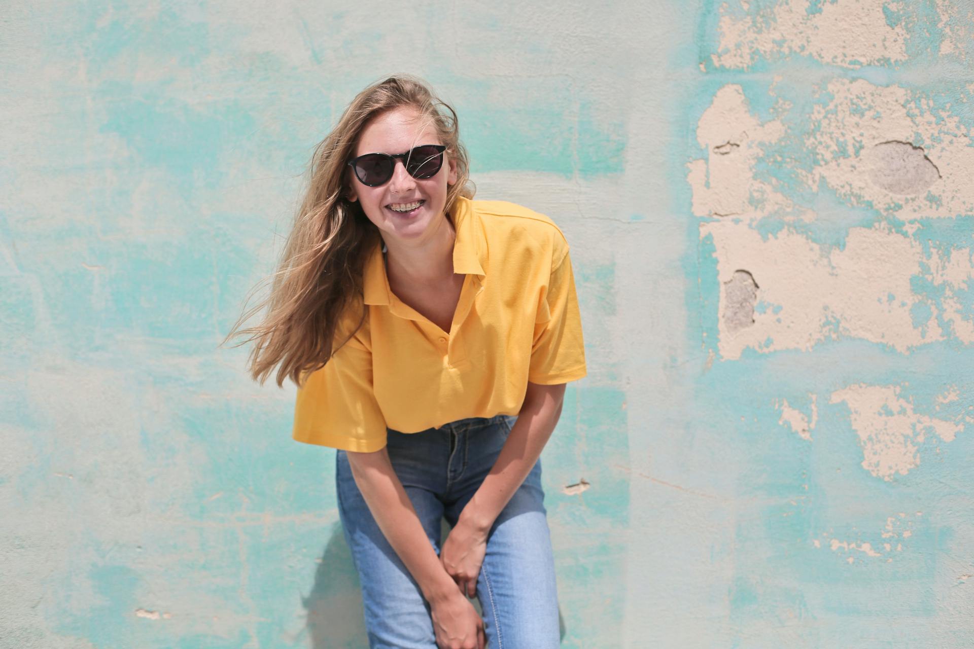 woman-yellow-shirt-smiling-glasses