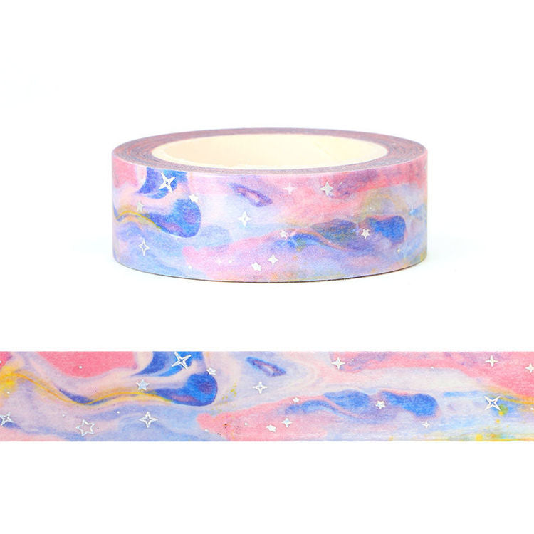 Image shows a washi tape with a blue and pink galaxy pattern