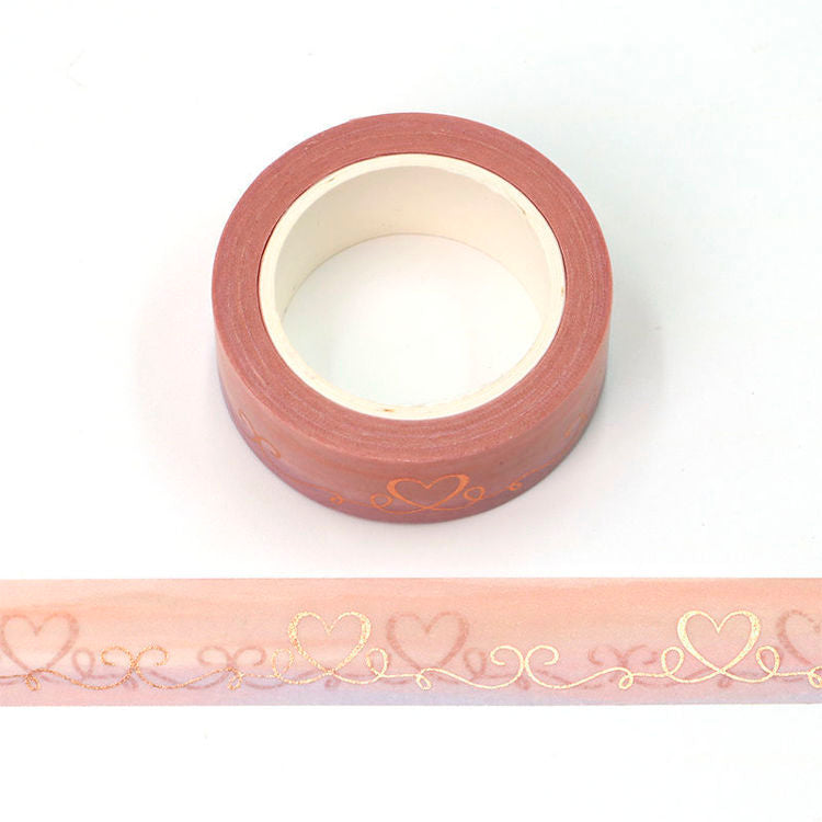 Image shows a pink washi tape with gold foil hearts
