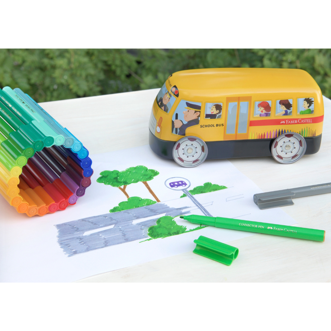 Image shows a school bus shaped tin with Faber-Castell pens