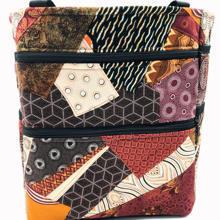 Patchwork-style teacher bag with geometric patterns on a white background