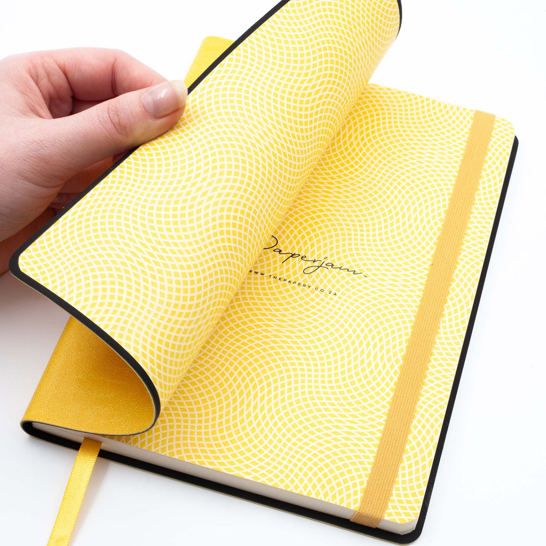 Image shows the endpapers of a yellow flexi softcover journal