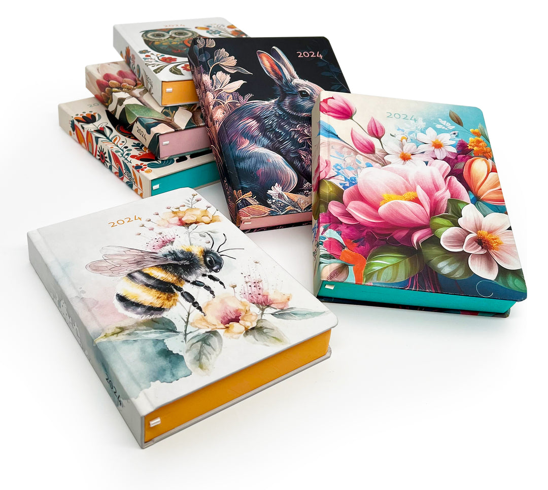 Image shows a group of printed MOM/WOW diaries