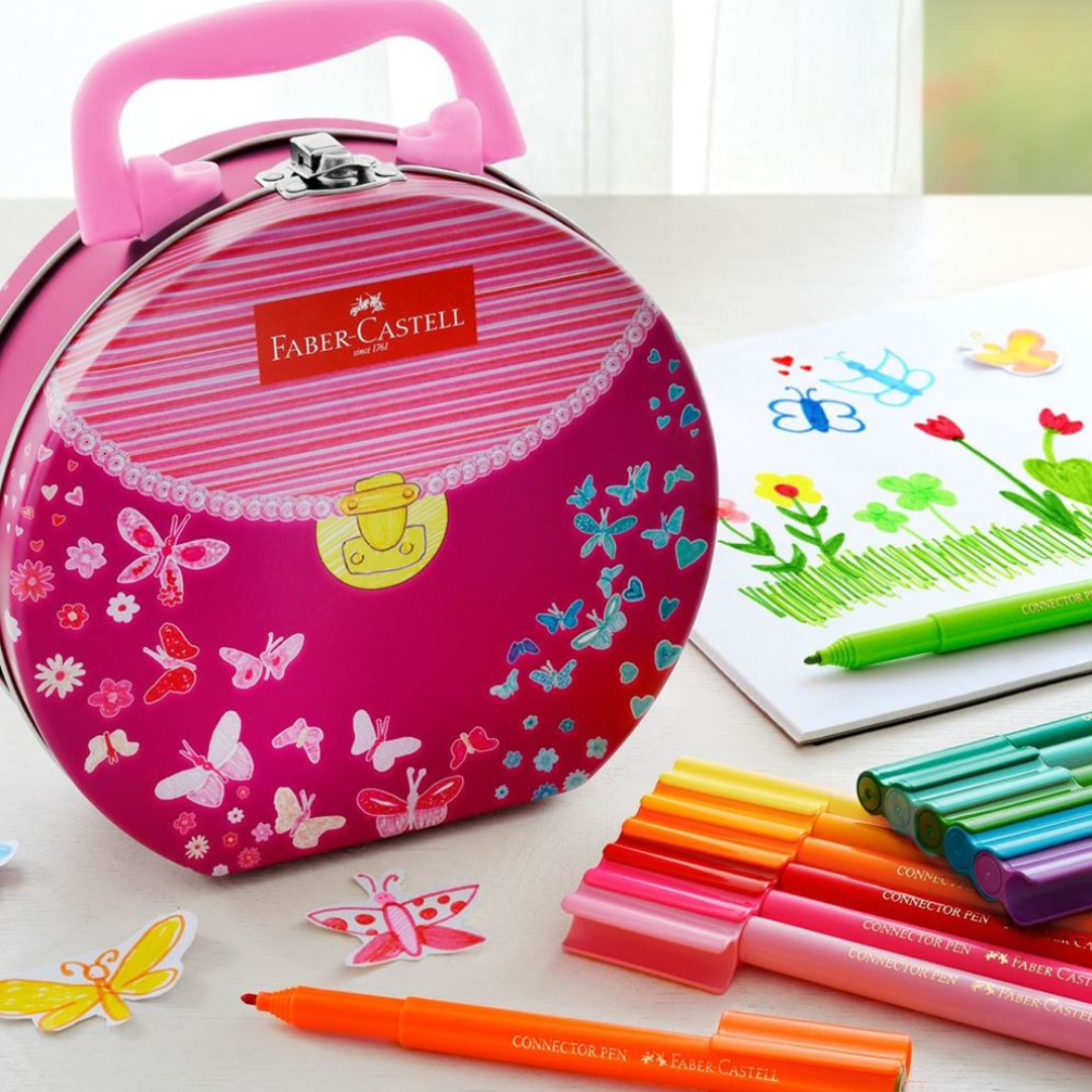 Image shows a handbag shaped tin with Faber-Castell pens 