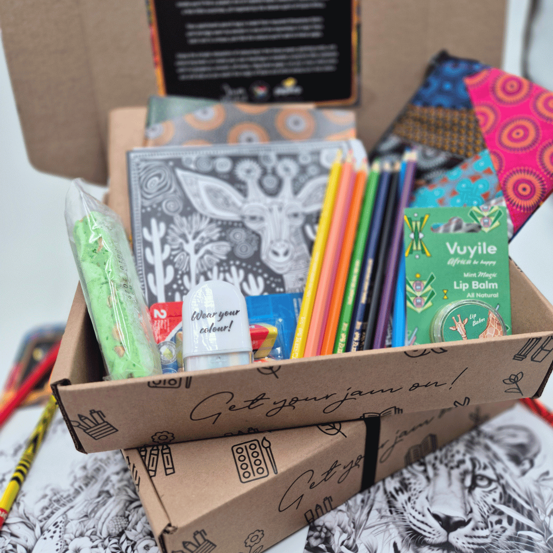 Box of stationery items including notebooks, pencils, and lip balm.
