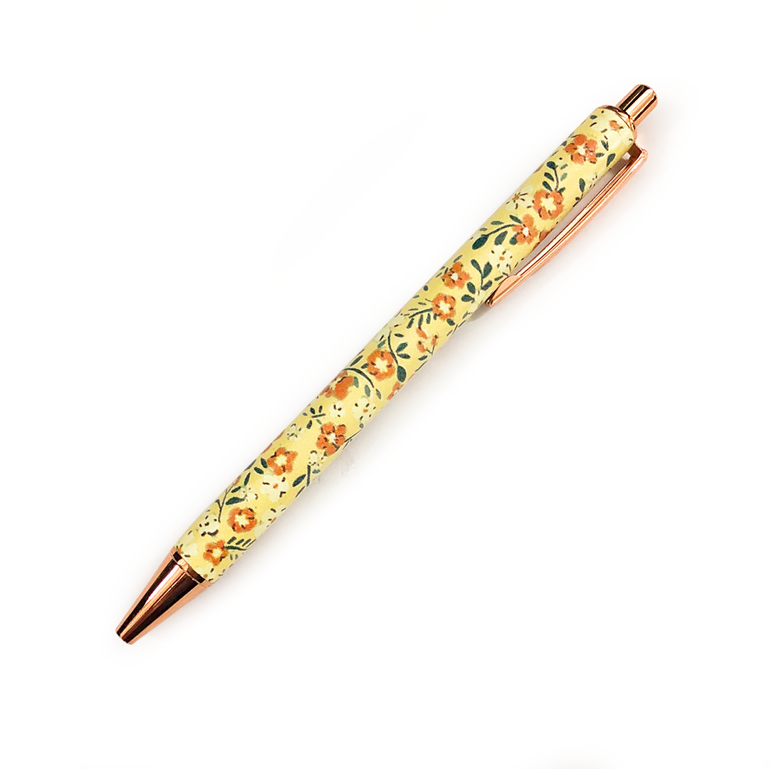 Image shows a ballpoint pen with a yellow flower design