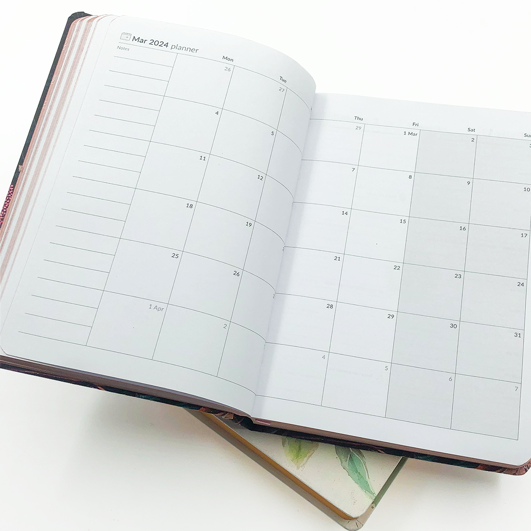 Image shows a monthly planner page in the MOM/WOW diary