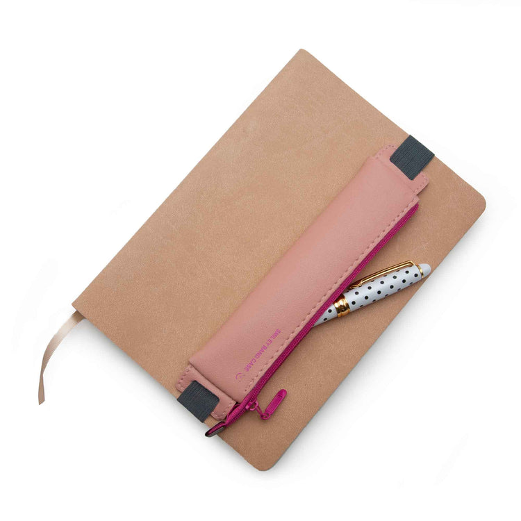 Image shows a pink diary/pencil pouch over a journal