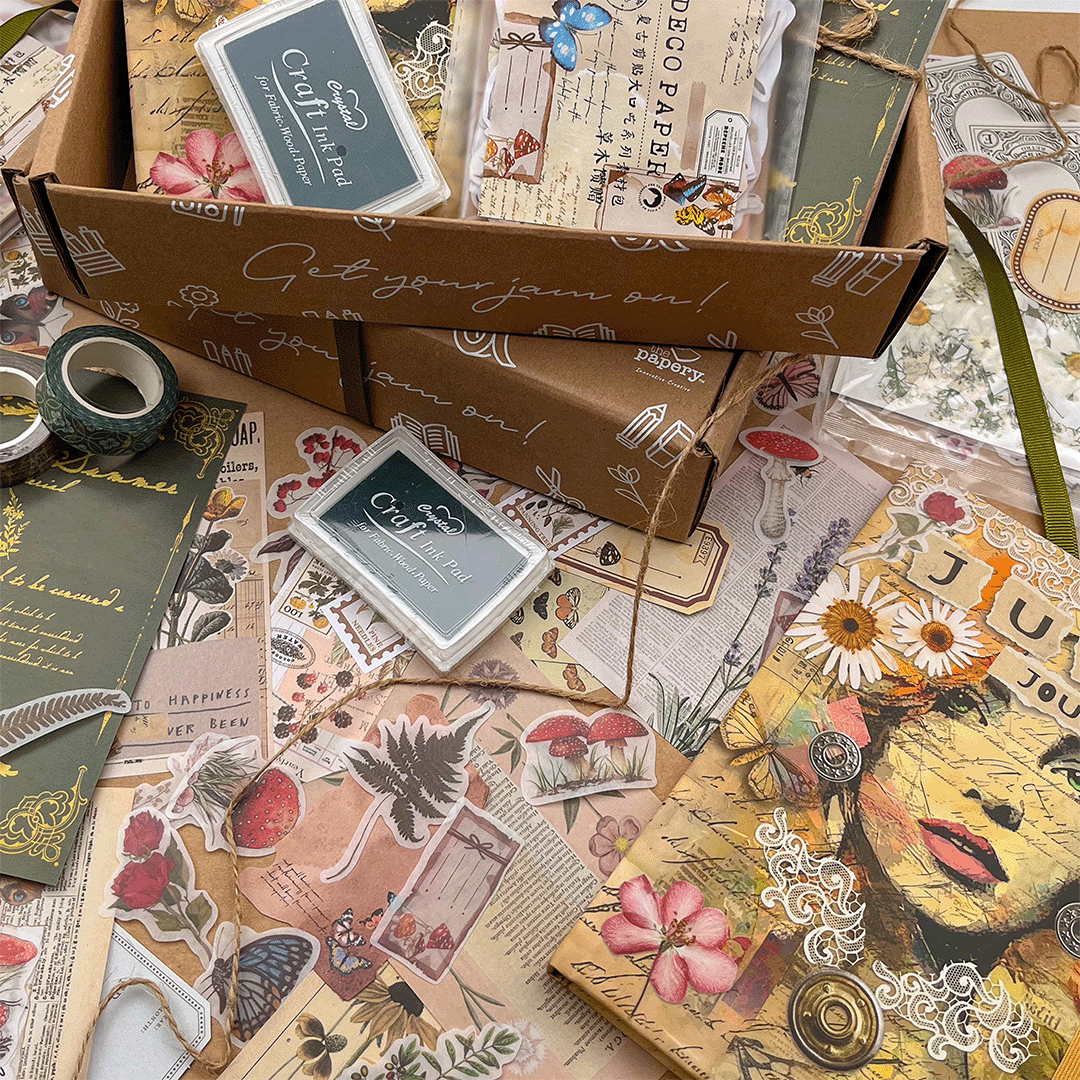Image shows the contents of a Junk journaling themed stationery box