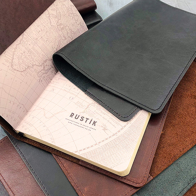 Image shows brown and black slip on leather covers with a journal inner