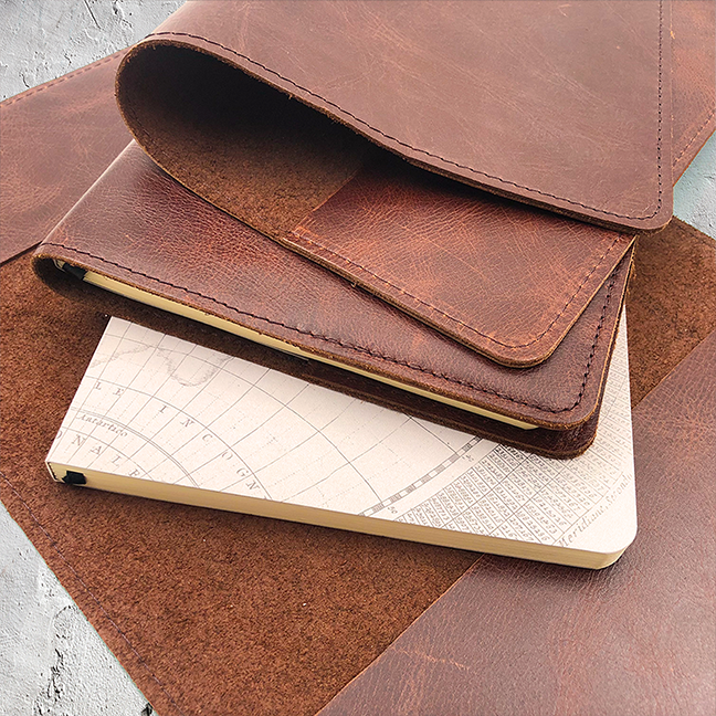 Image shows a brown slip on leather cover with journal inner