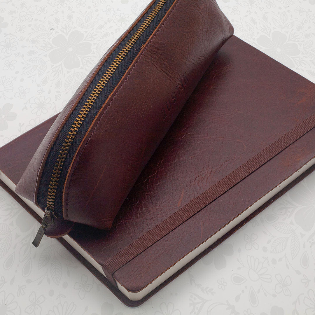 Image shows a Rustik premium journal and a Rustik Leather pencil bag 