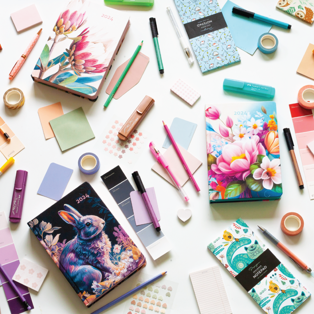 Image shows MOM/WOW diaries in different covers with various stationery