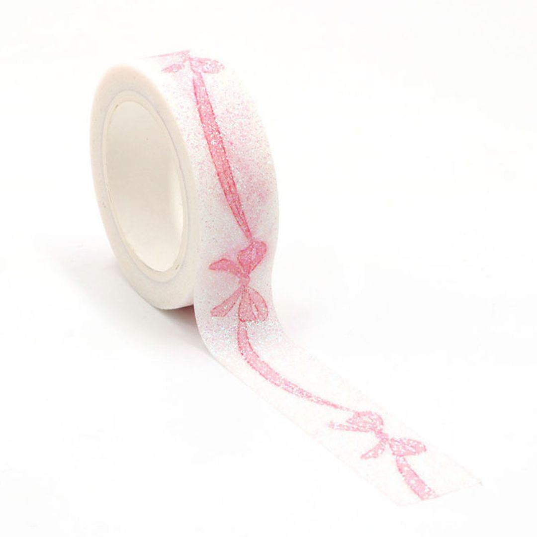 Roll of decorative washi tape with pink butterfly pattern on a white background