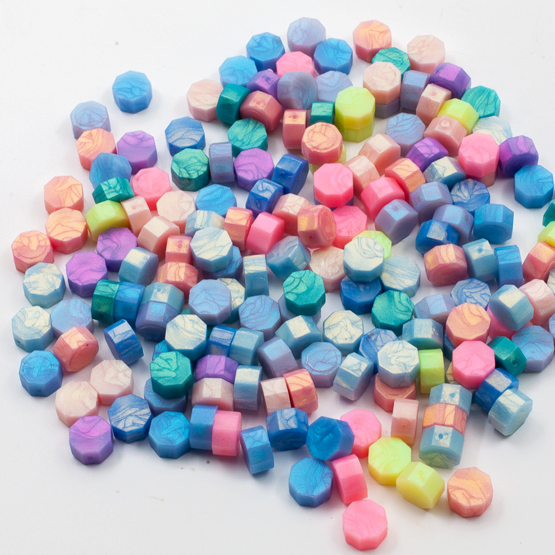 Image shows a set of rainbow wax pellets