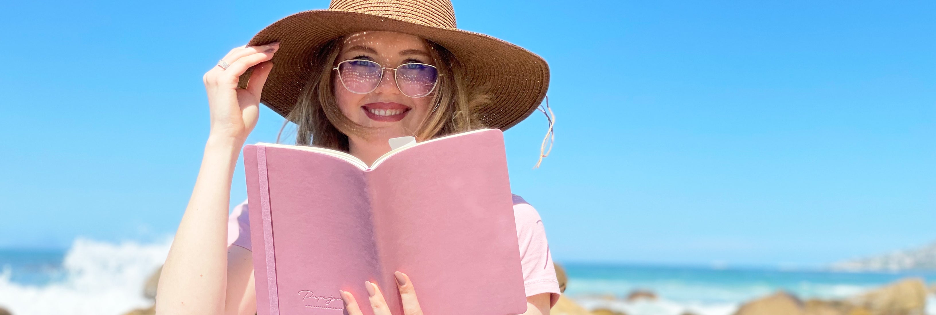 Image shows a woman holding a Flexi softcover journal in and 