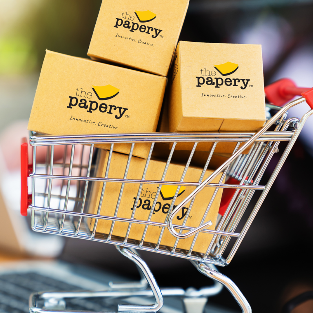 Image shows a shopping cart with boxes, labeled "The Papery"
