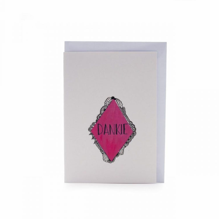 Image shows a greeting card with "Dankie" written on it in a triangular illustration