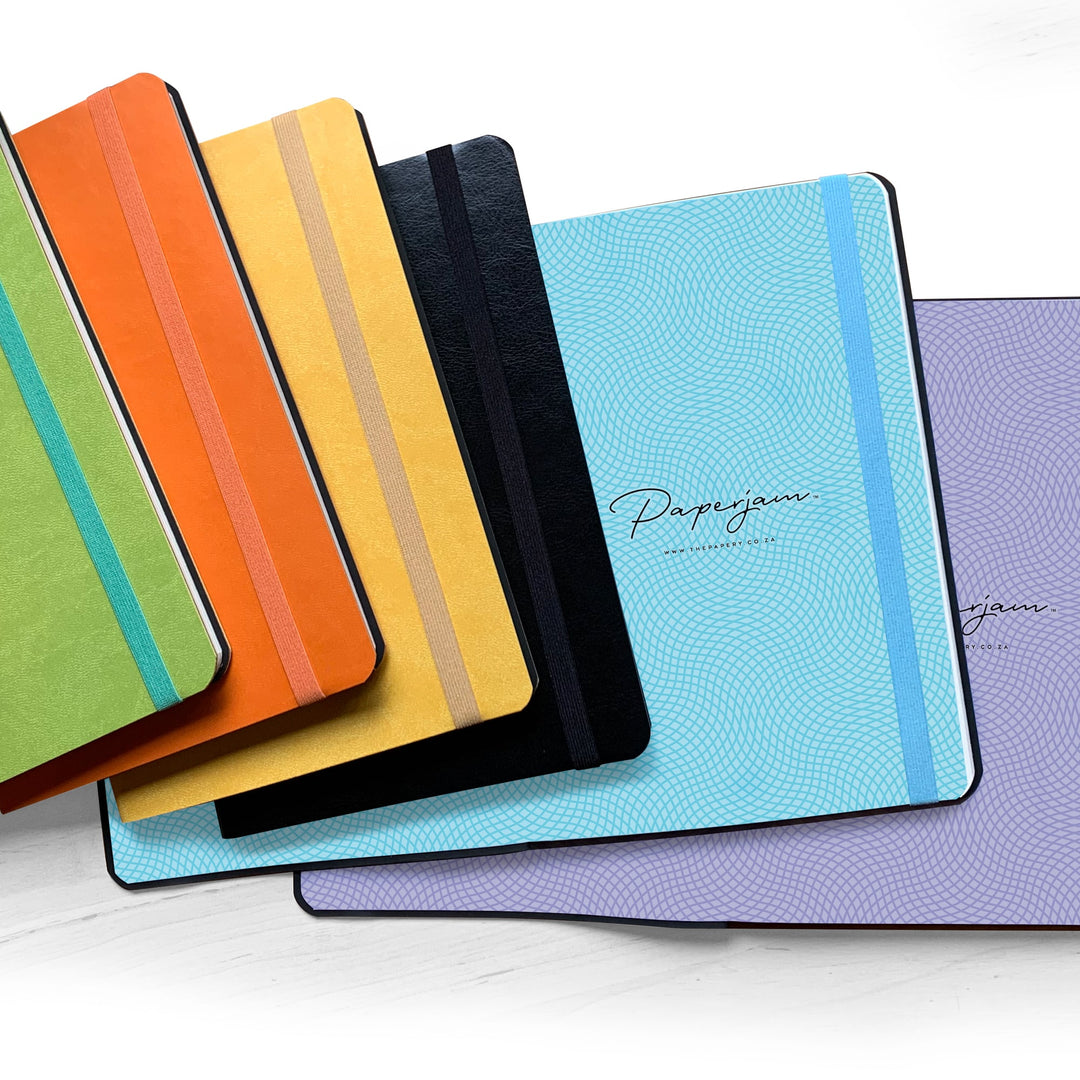 Image shows a group shot of the Flexi softcover journals (showing some enpapers)