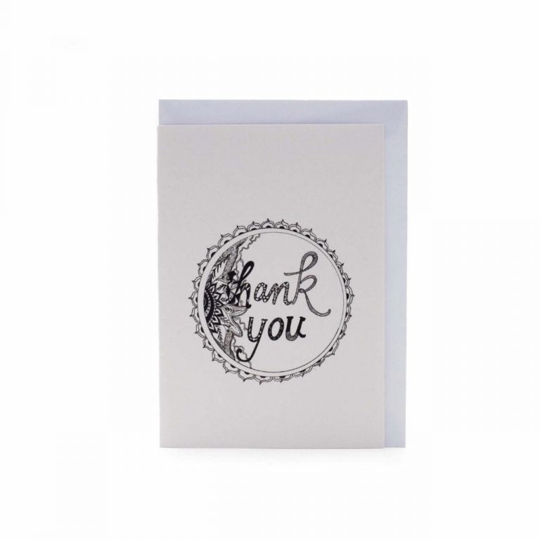 Image shows a greeting card with "thank you" written on it in a floral illustration