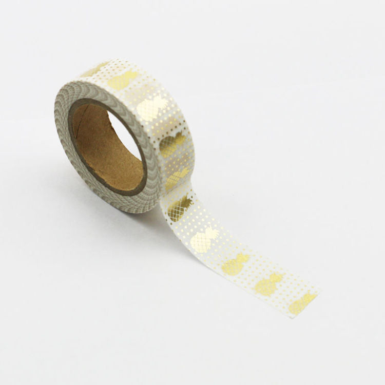 Image shows a white with gold pineapples pattern washi tape