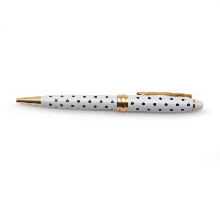 Image shows a white ballpoint pen with black polka dots