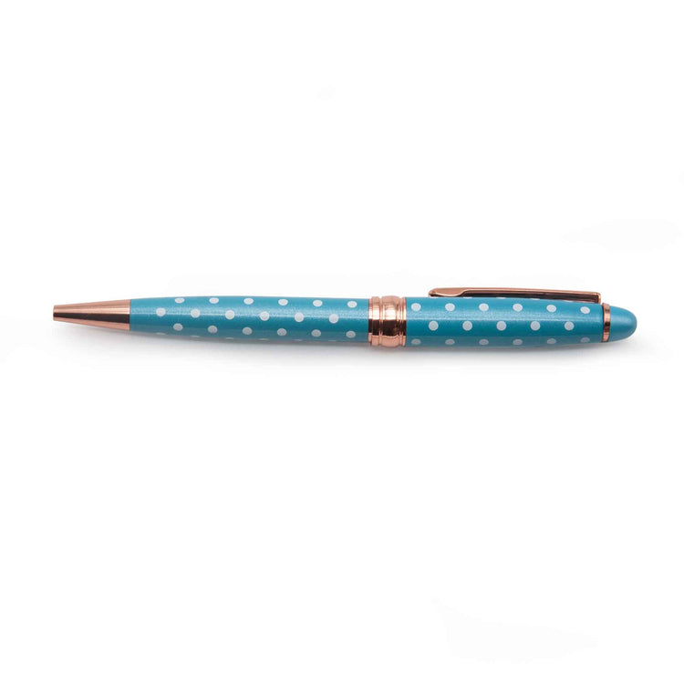 Image shows a blue ballpoint pen with white polka dots