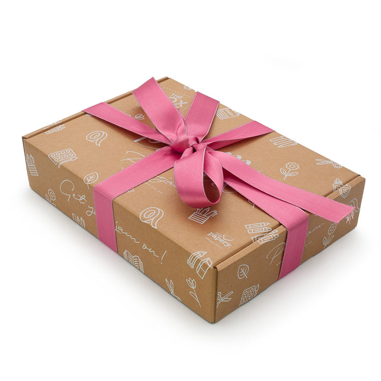 Image shows a jam packed box with pink ribbon