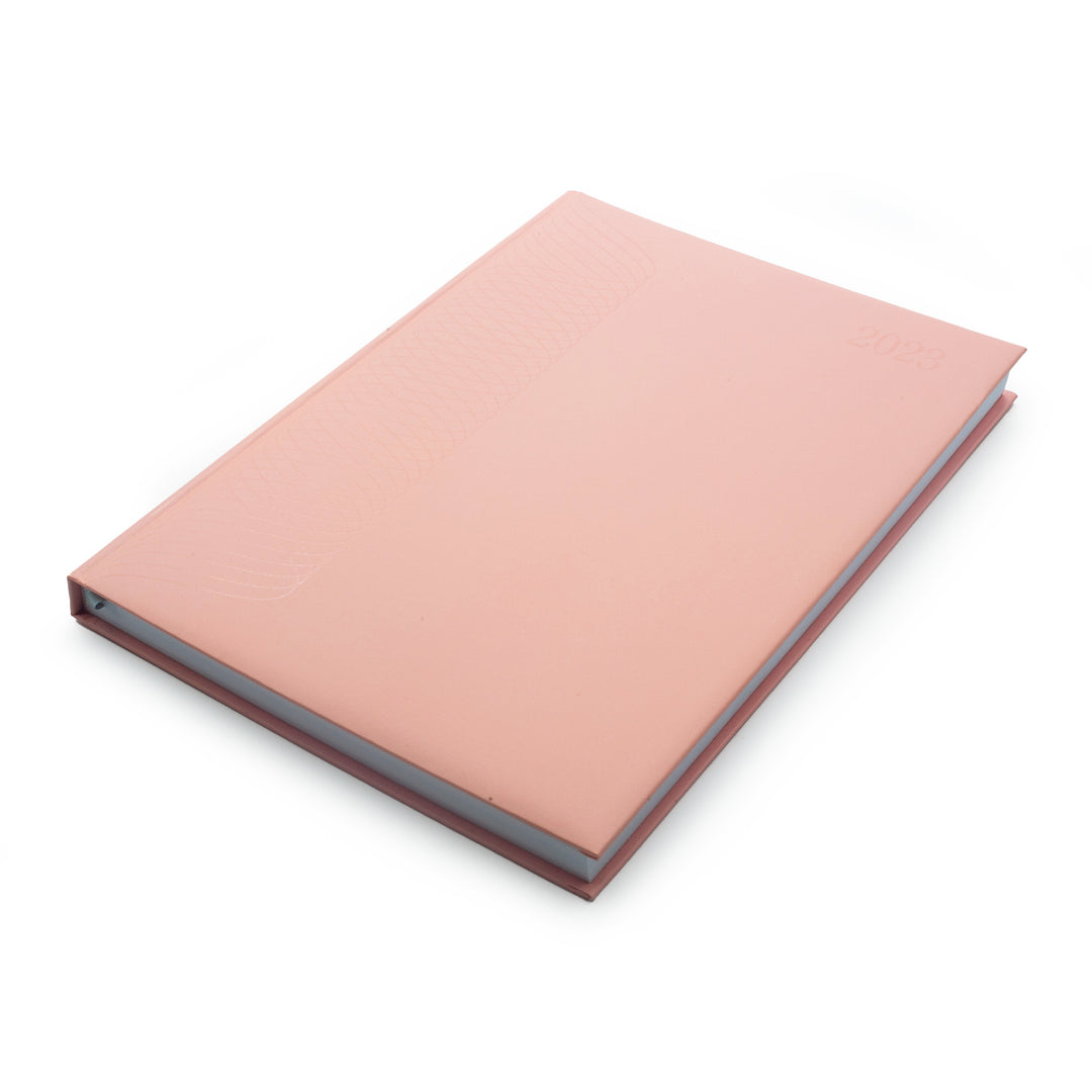 Image shows the top front view of a pink A4 2023 planner