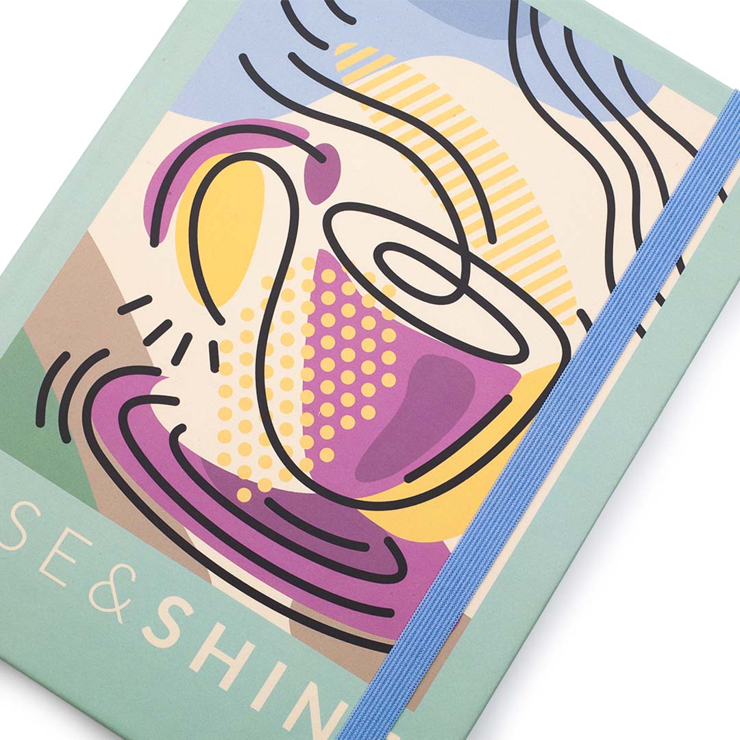 Image shows a close up, front top view of a Retro Rise & Shine journal
