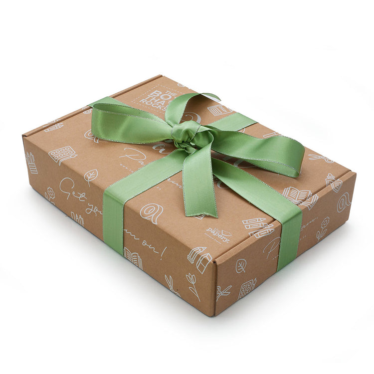 Image shows a jam packed box with green ribbon