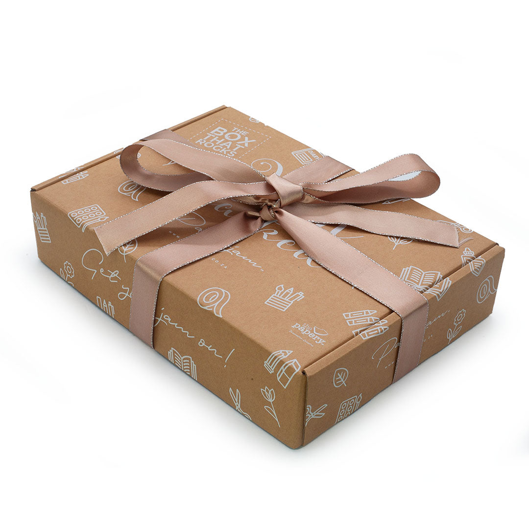 Image shows a jam packed box with brown ribbon