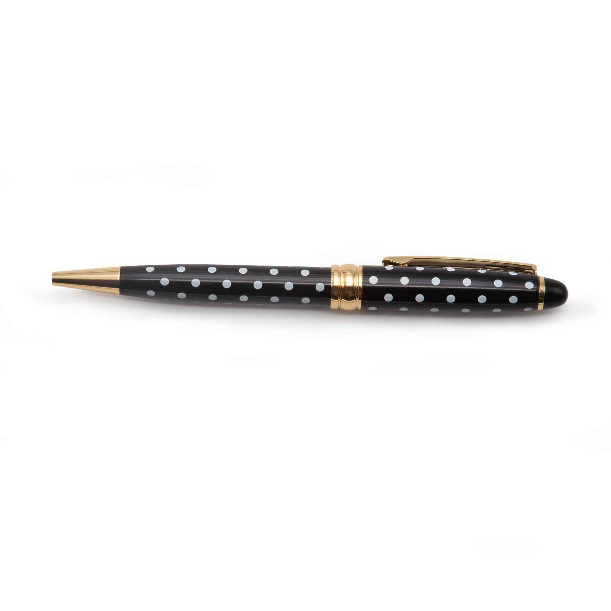 Image shows a black ballpoint pen with white polka dots